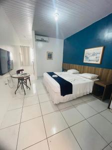 a bedroom with a bed and a table in it at Ocean Praia Hotel in Fortaleza