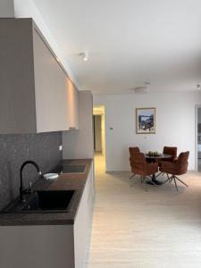 a kitchen with a sink and a table with chairs at Navis Suites & Spa in Mandre +67 photos