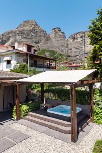 a pergola with a swimming pool in front of a mountain at Meteora boutique villa E in Kalabaka +54 photos