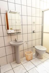 a bathroom with a sink and a toilet at Hotel Descalvado in Descalvado +71 photos