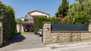 a bench on a stone wall in front of a house at Meteora boutique villa E in Kalabaka