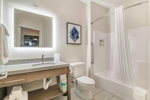 a bathroom with a toilet and a sink and a shower at Candlewood Suites Longview by IHG in Longview +33 photos