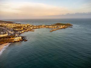 an aerial view of a city and the ocean at 1 Bed in St. Ives oc-e28023 in St Ives +9 photos