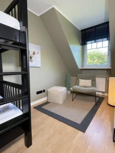 a bedroom with a bunk bed and a living room at 4Strandzeiten - Ferienhaus Luv in Timmendorfer Strand