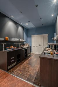 a large kitchen with counters with food on display at Klostermühle in Groß Meckelsen +54 photos