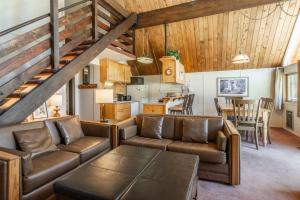 a living room with a couch and a table at Chalet 15 by Mammoth Mountain Chalets in Mammoth Lakes