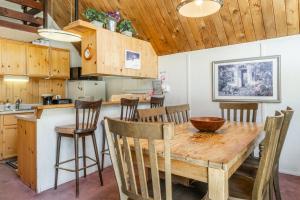 a kitchen and dining room with a wooden table and chairs at Chalet 15 by Mammoth Mountain Chalets in Mammoth Lakes