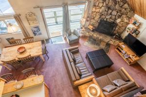 an overhead view of a living room with a stone fireplace at Chalet 15 by Mammoth Mountain Chalets in Mammoth Lakes