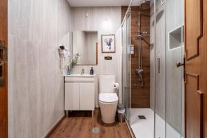 a bathroom with a toilet and a sink and a shower at Guest House Da Mata3 in Póvoa de Varzim +54 photos