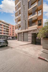 a parking lot in front of a building at Prime location Moroccan-Style Luxury Apartment with Parking near Carré Eden Shopping Center in Marrakesh