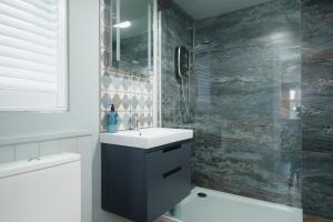 a bathroom with a sink and a toilet and a shower at Lowcross House in Whitchurch +30 photos