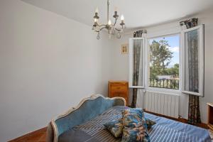ein Schlafzimmer mit einem Bett und einem Fenster in der Unterkunft Villa Same in Saint-Maximin-la-Sainte-Baume + 13 Fotos