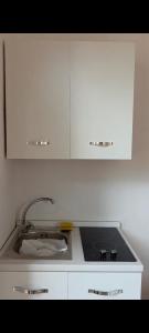 a kitchen counter with a sink and a stove at Le Suite dei Due Mari cucinino privato in Taranto
