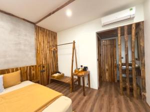 a bedroom with a bed and a table in it at Suối Mộc Ecostay - Mộc Châu in Mộc Châu +31 photos
