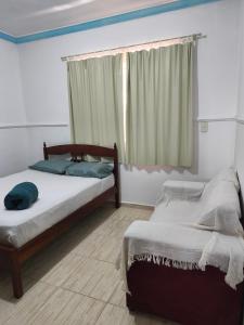 a bedroom with two beds and a window at Casa ampla in Muriaé +8 photos