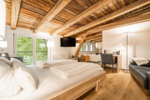 a bedroom with a large white bed and a desk at Klostermühle in Groß Meckelsen