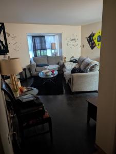 a living room with a couch and a table at Lucky get away in Poughkeepsie +2 photos