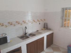 a kitchen with a sink and a counter top at DAVADI loc in Cotonou