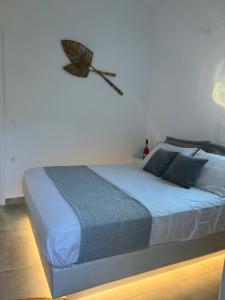 a bedroom with a bed with a butterfly on the wall at The Dream in Ios Chora