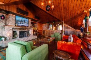 a living room with a couch and a fireplace at Hazaar Dastaan Kashmir in Srinagar