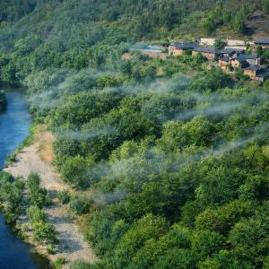 an aerial view of a river with trees and houses at Casa da Azenha- Riverside Retreat by Paiva River Beach in Paradinha +55 photos