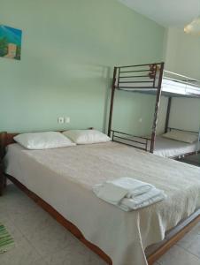 a bed with two bunk beds in a room at Irida maria Family studios in Agios Ioannis Pelio