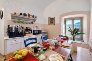 a kitchen with a table with food on it at Villa Piuma in Finale Ligure