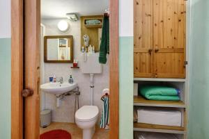 a small bathroom with a toilet and a sink at Villa Piuma in Finale Ligure +54 photos