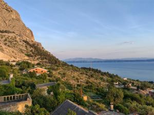 a view of a village on a hill with the water at Holliday home Alida with jacuzzi in Podgora