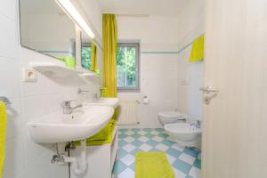 a bathroom with two sinks and two toilets at Residence Passerhaus in Schenna +107 photos