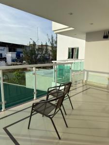 a chair sitting on top of a balcony at Hotel Califórnia in Canindé