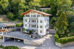 an aerial view of a white house with a balcony at Residence Passerhaus in Schenna