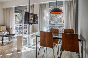 a living room with a dining room table and chairs at Color Botánico in Buenos Aires