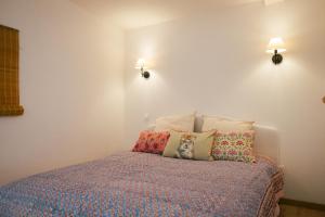 a bedroom with a bed with pillows on it at Kuching in Arles