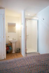a bathroom with a shower and a sink at Kuching in Arles