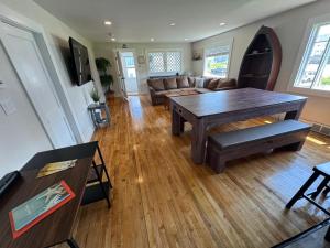 a living room with a table and a couch at Sun2Sand Beach House in Salisbury