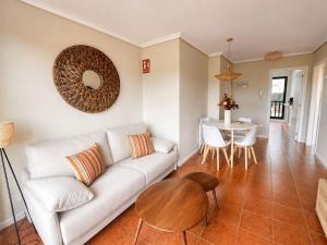 a living room with a white couch and a table at Apartamento Guou in Comillas