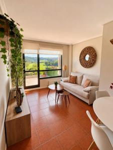 a living room with a couch and a table at Apartamento Guou in Comillas