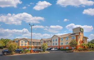 a hotel with a clock tower in a parking lot at Extended Stay America Suites - St Petersburg - Clearwater - Executive Dr in Clearwater