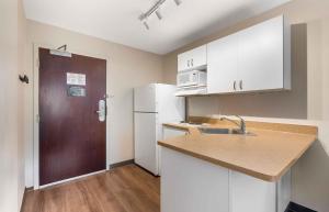 a small kitchen with a sink and a refrigerator at Extended Stay America Suites - St Petersburg - Clearwater - Executive Dr in Clearwater