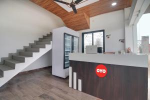 a kitchen with a counter and stairs in a house at Hotel O Goyal Inn in Nagpur