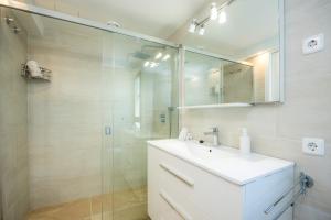 a bathroom with a sink and a glass shower at Ana Playasol in Port d'Alcudia +25 photos