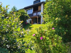 a house with a bunch of flowers in the yard at Schöne Aussicht in Todtnau