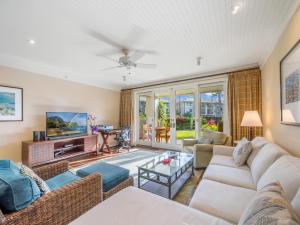 a living room with a couch and a table at 3-Bed Villa 115 at Turtle Bay in Kahuku