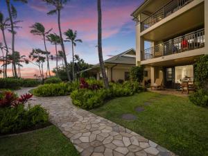 a backyard of a house with a walkway at 3-Bed Villa 115 at Turtle Bay in Kahuku
