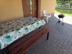 a bed and a bench with a grill and a chair at 9 Dańce - comfortable accommodation 22-220 - WIFI included in Dańce
