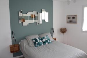 a bedroom with a bed and a painting on the wall at Vue sur les Pyrénées in Madiran