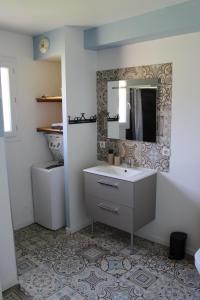 a bathroom with a sink and a mirror at Vue sur les Pyrénées in Madiran +31 photos