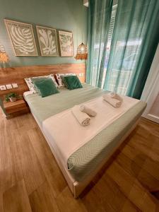 a bedroom with a large bed with green pillows at ΑVLI Sarti Superior Studio no5 in Sarti