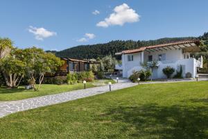 a villa with a garden and a house at m&m in Vourvourou